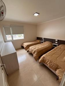 En eller flere senge i et værelse på Complejo ALI121 Las Grutas