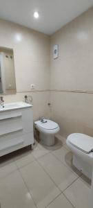 a white bathroom with a toilet and a sink at Apartamento Vistas al mar en Gemelos 24 La Cala de Finestrat in Alicante