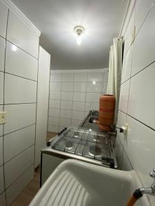 a kitchen with a stove top in a room at Apartamento no Ilha Bela 2 in Caldas Novas