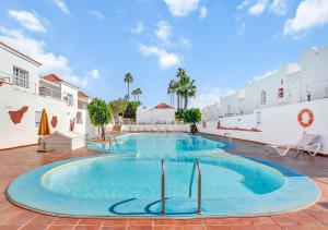 a large swimming pool in a building with a sky background at Silvic Serenada in Corralejo