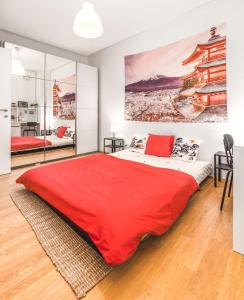 a bedroom with a bed with a red blanket at Relaxed Zen-Apartment in top area and amazing view in Vienna