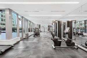 a gym with treadmills and machines in a building at Modern Seaport Oasis in Boston