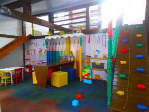 a play room with a climbing wall and a rock wall at Pousada Sonho de Geribá in Búzios