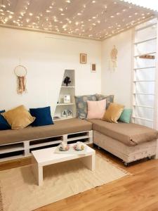 a living room with a couch and a coffee table at Le Sable d'Or - charme - détente in Amiens