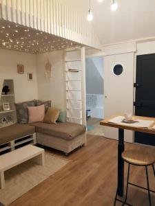 a living room with a couch and a bunk bed at Le Sable d'Or - charme - détente in Amiens