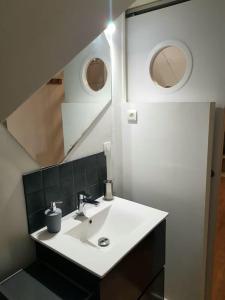 a bathroom with a sink and a mirror at Le Sable d'Or - charme - détente in Amiens