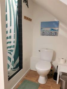 a bathroom with a toilet and a sign on the wall at Le Sable d'Or - charme - détente in Amiens