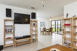 a living room with a flat screen tv on a wall at Addy by the Lake in Port Charlotte