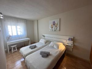 a bedroom with two beds and a window at Mara apartment with beautyful oceanview in Playa de las Americas