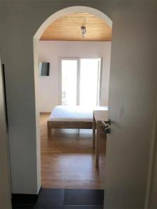 an open door to a bedroom with a bed and a table at Kleines gemütliches Studio 1 in Moselnähe in Zeltingen-Rachtig