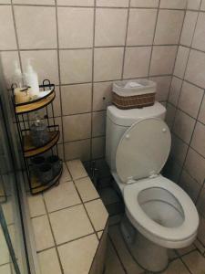 a bathroom with a toilet in a tiled room at Kganya@Sunset Lodge in Phalaborwa