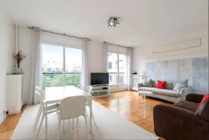 a living room with a table and a couch at Avenue Montaigne Paris Bienvenue in Paris