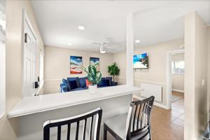 a kitchen and dining room with two chairs and a bar at Beach Apartment Walk Downtown in Santa Barbara