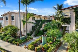 a house with palm trees in front of it at Funk Zone Apartment Walking Distance to the Beach in Santa Barbara