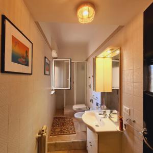 a bathroom with a sink and a toilet at Un Letto sul Mare (vit vit vit) in Marsala