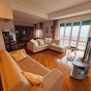 a living room with two couches and a television at Un Letto sul Mare (vit vit vit) in Marsala