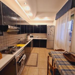 a kitchen with a sink and a refrigerator at Un Letto sul Mare (vit vit vit) in Marsala