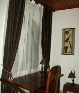 a dining room table in front of a curtain at Iarimbato Hotel in Antananarivo