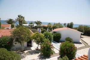 a view of a garden with trees and bushes at Kefalonia Beach Hotel & Bungalows in Lixouri