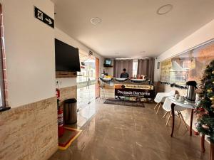 a living room with a christmas tree and a kitchen at Pousada Diamante in Ubajara