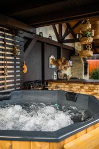 a bath tub filled with water in a kitchen at Hanul Anei - entire property in Braşov