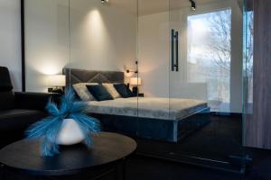 una camera con un letto con una parete in vetro di Kras Resort Apartament 110 z prywatnym jacuzzi i widokiem na góry a Szklarska Poręba Altre 21 foto