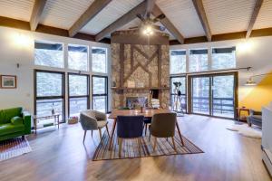 a living room with a table and chairs at Mid-Century Cabin Creekside, Easy Access to i-70 in Dumont