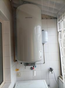 a water tank on the wall of a bathroom at Yellow House in Senhora da Hora