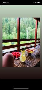 a table with food and drinks on a balcony at Cabana Loredana in Vadu Moţilor