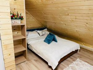 Habitación con cama en una cabaña de madera en Cabana Loredana, en Vadu Moţilor