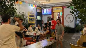a group of people standing around in a restaurant at Viajero CDMX Centro Hostel in Mexico City