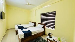 Katil atau katil-katil dalam bilik di Mystique Inn Wayanad