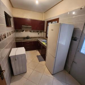 a kitchen with a white refrigerator and a counter at B 1 apartment in Fès