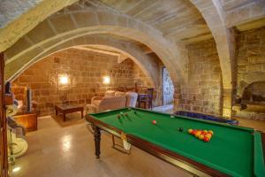 a living room with a pool table in a castle at 5 Bedroom Farmhouse with Private Pool & Views in Għarb