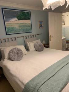 a bedroom with a bed with two pillows on it at CreekSide Bed and Breakfast Faversham in Faversham