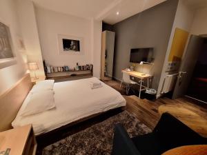 a bedroom with a white bed and a desk at cool room in shared house in York