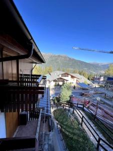 a balcony of a building with a view of a river at Nido Alpino - by Lucia vacanze 13 in Folgarida