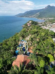 an aerial view of a resort on a hill next to the ocean at Azur Guesthouse in Ilhabela