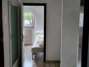 a bedroom with a bed and a window and a mirror at Oaza mira in Osijek