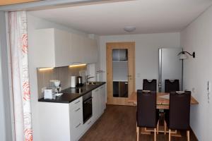 a kitchen and dining room with a table and chairs at Schottar FeWo ST 09 in Dornbirn