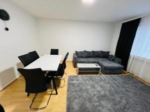 ein Wohnzimmer mit einem Tisch und einem Sofa in der Unterkunft E & N Apartments in Oberhausen