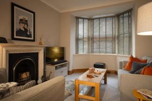 a living room with a couch and a fireplace at Fairmead in Ambleside