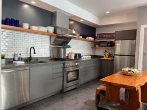 a kitchen with stainless steel appliances and a wooden table at Petaluma Warehouse Lofts unit E in Petaluma +9 photos