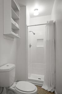 a white bathroom with a toilet and a shower at Inn at Sugar Pine Ranch in Groveland +120 photos