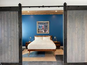 a bedroom with a bed and a blue wall at Petaluma Warehouse Lofts unit E in Petaluma