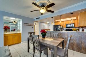 a dining room with a table and a ceiling fan at Florida Apartment with Balcony, Pool Access and Views in Panama City Beach