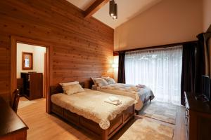 a bedroom with two beds and a window at Villa Katerina Deluxe - Pirin Golf and Country Club in Bansko +49 photos