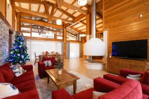 a living room with a christmas tree and a television at Villa Katerina Deluxe - Pirin Golf and Country Club in Bansko
