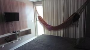a hotel room with a bed and a window at Apartamento West Flat Ap401 in Mossoró