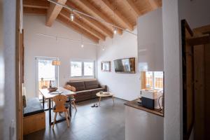 a living room with a couch and a table at Palazi Apartments & Spa - Bike, Ski & Wellness in Nauders in Nauders